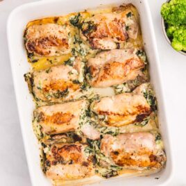 a pan of stuffed chicken thighs with spinach and cheese