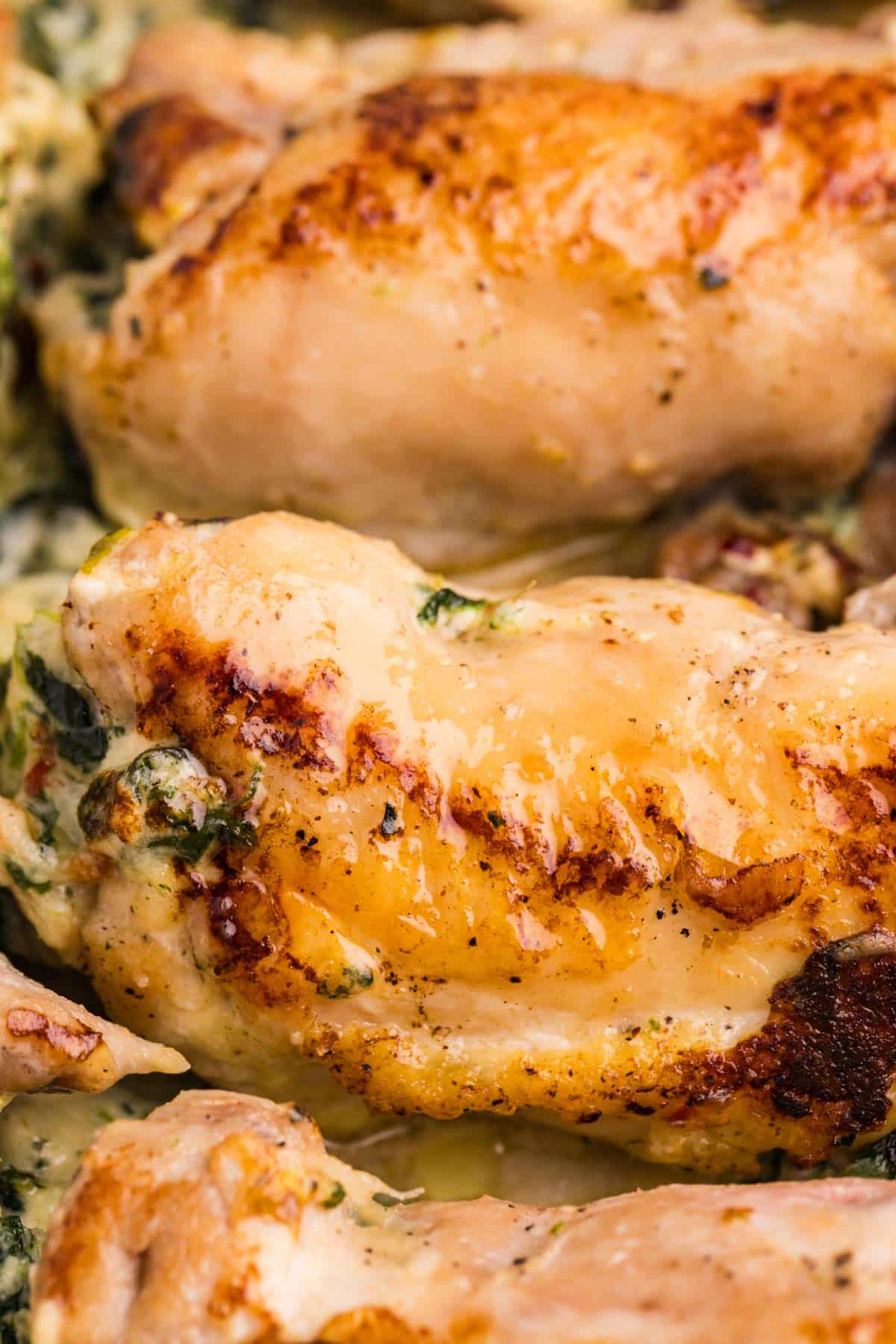 closeup of baked chicken thighs in a roasting pan