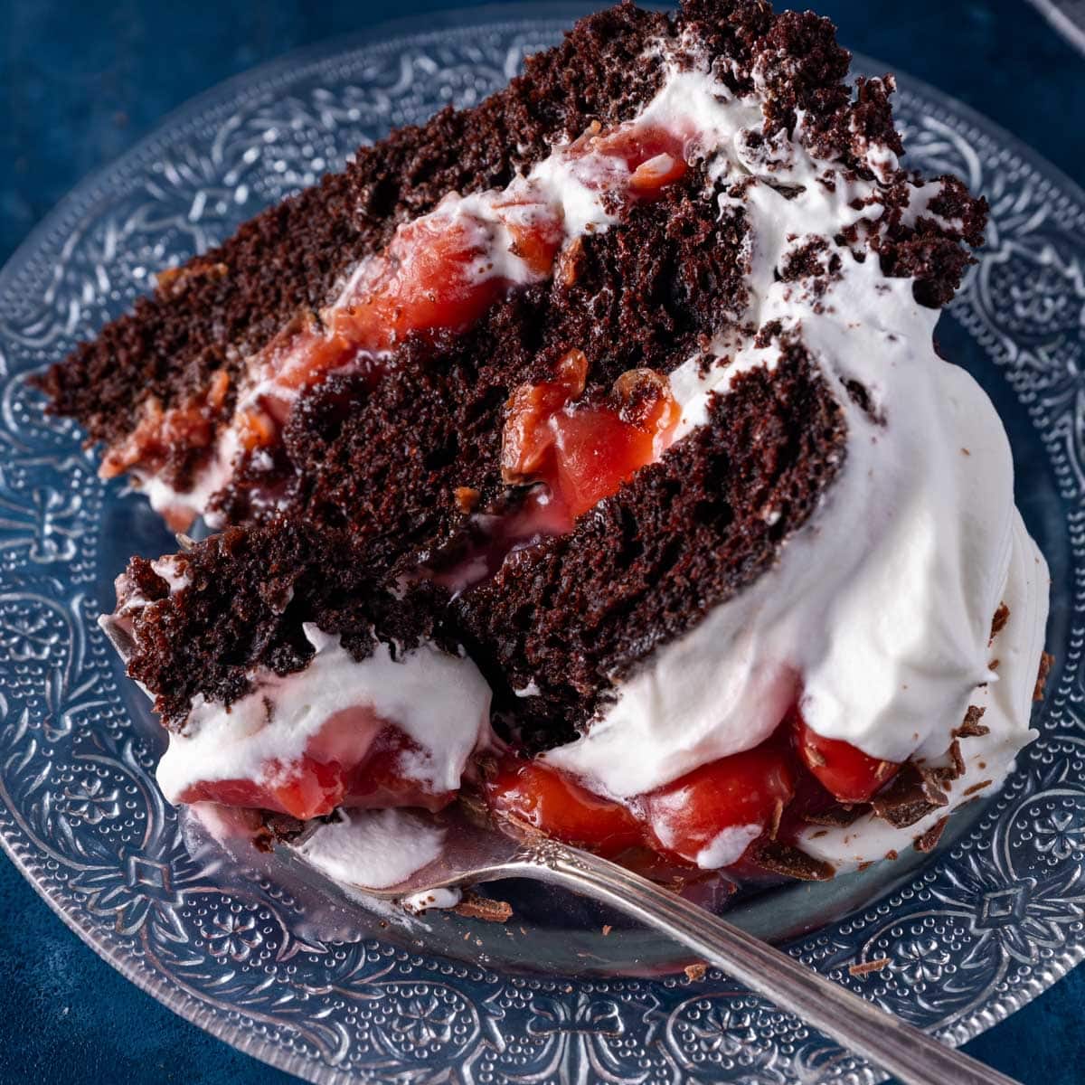 a piece of layered black forest cake on a plate