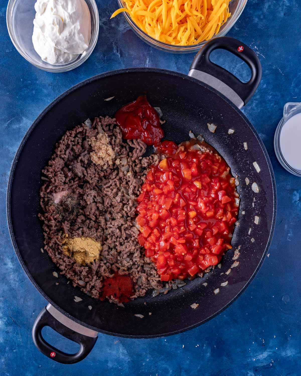 ground beef, seasonings and tomatoes in a skillet