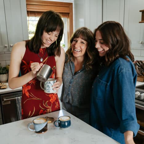 three girls standing in a kitchen