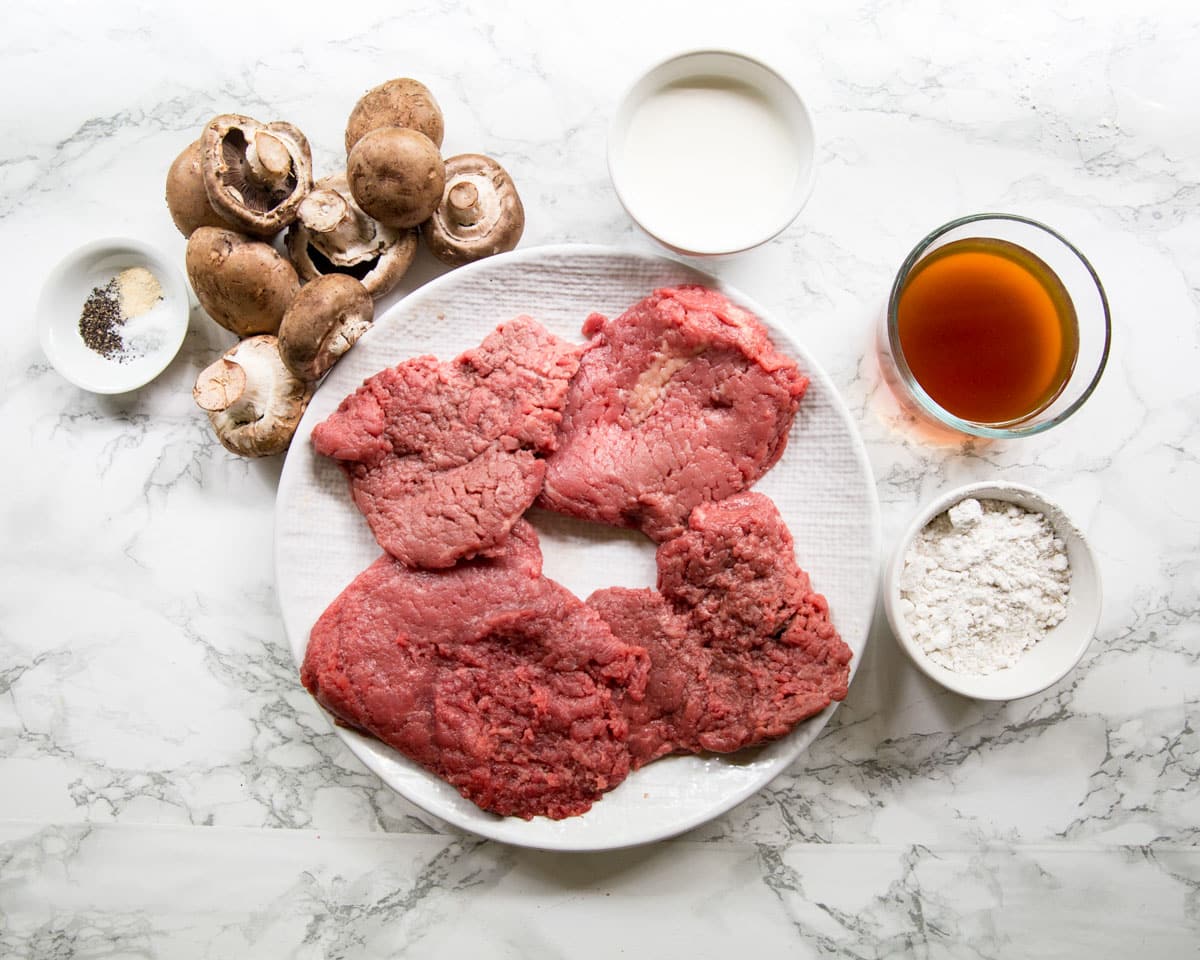 ingredients for cube steak and mushroom gravy on a table