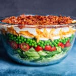 seven layer salad in a glass bowl