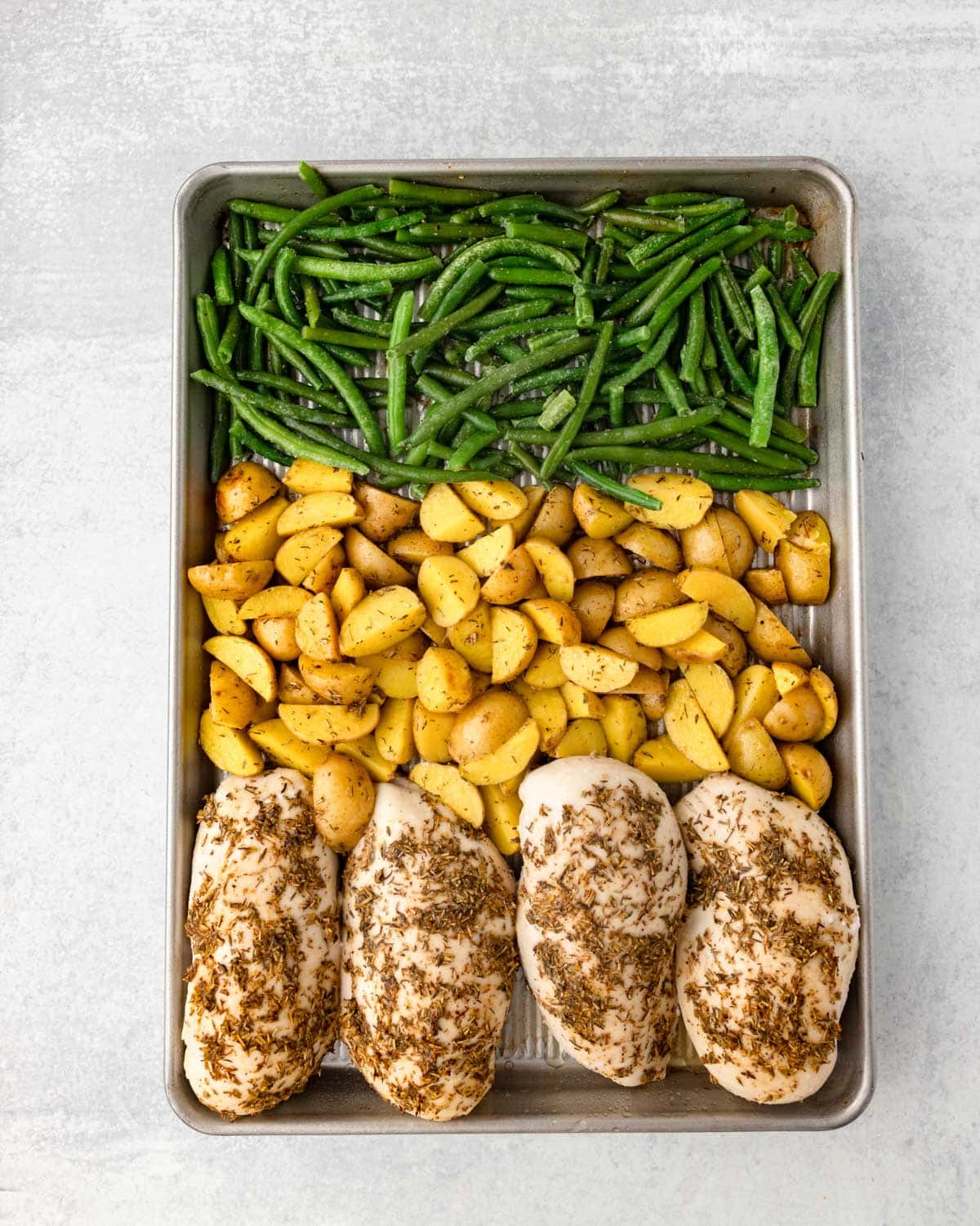 green beans, potatoes and chicken on a sheet pan