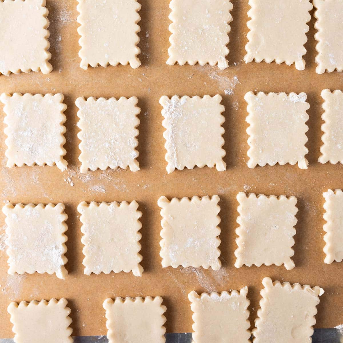 unbaked cookie shapes on parchment paper