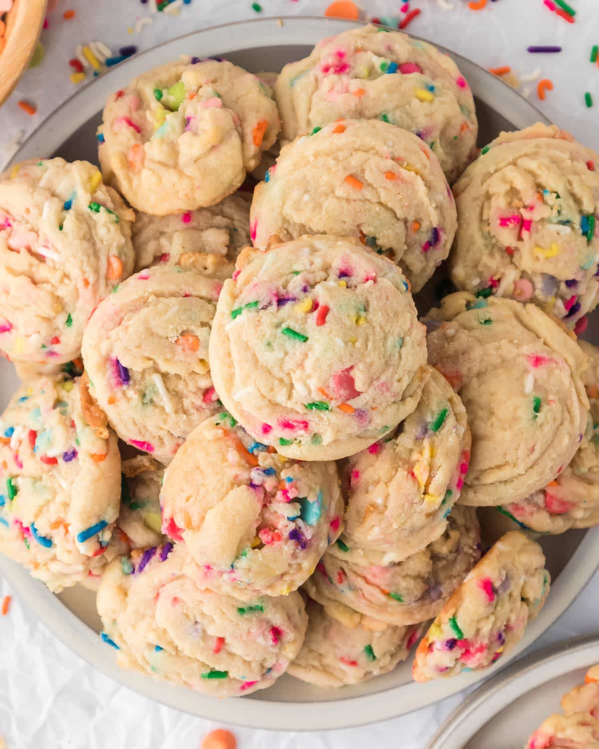 sprinkle cookies on a plate with rainbow chips