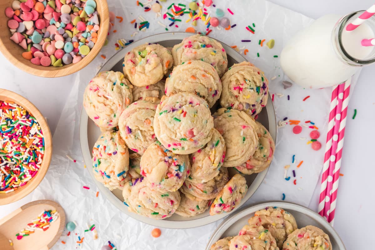 overhead view of a pile of birthday cookies with sprinkles on a plate