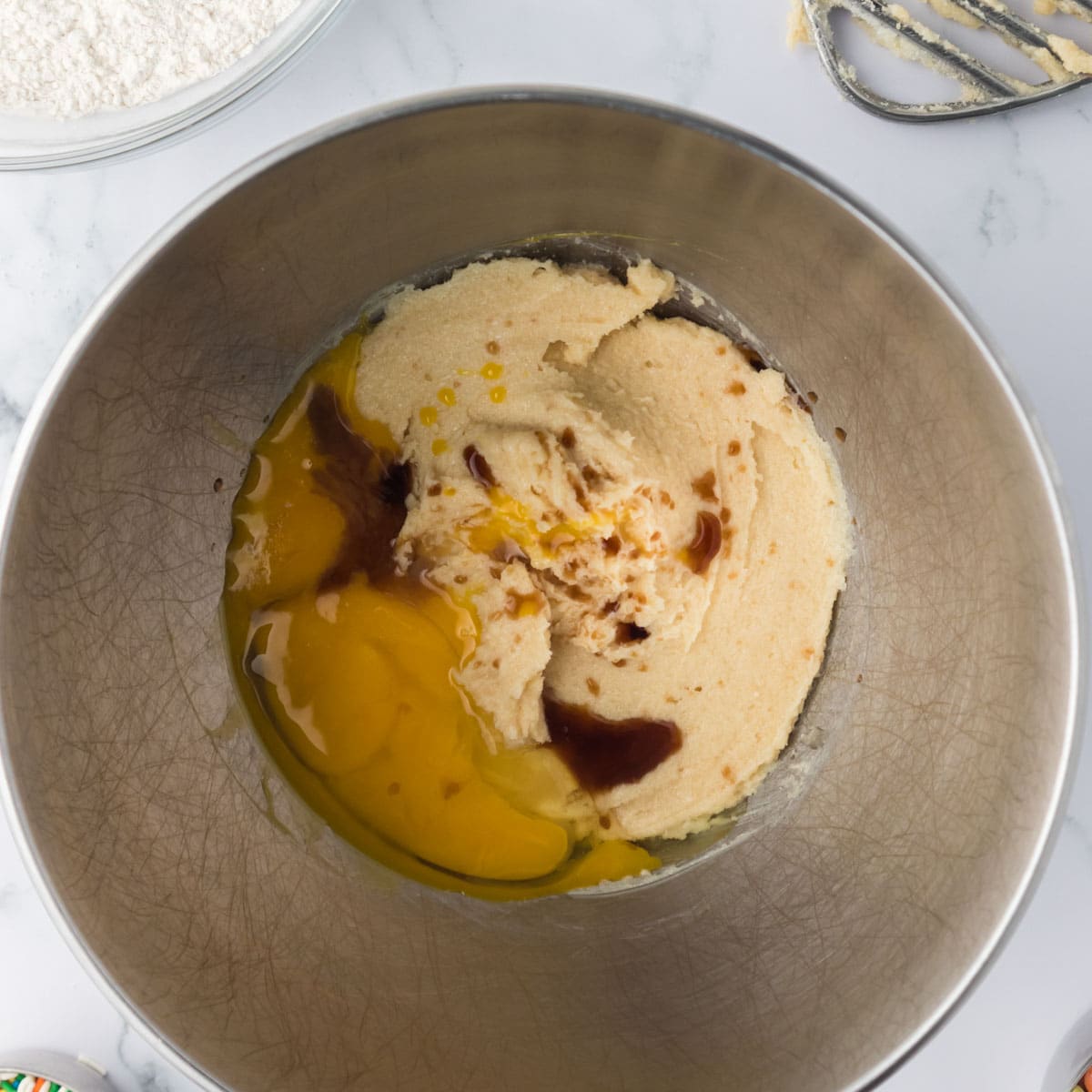 eggs and vanilla over cookie dough in a bowl