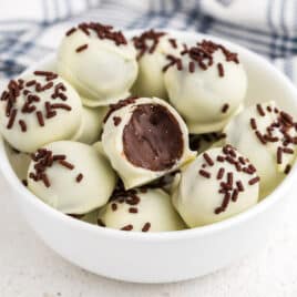 a bowl of brownie truffles with white chocolate, one cut in half