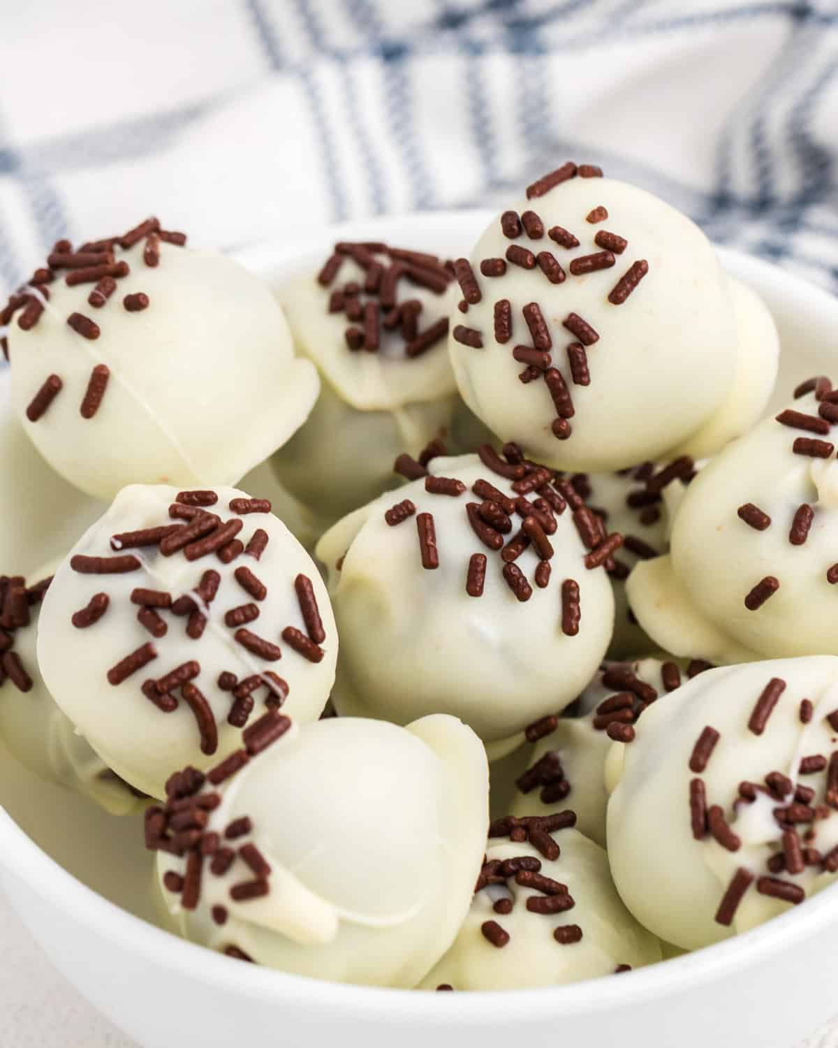 a bowl of brownie truffles with white chocolate and sprinkles