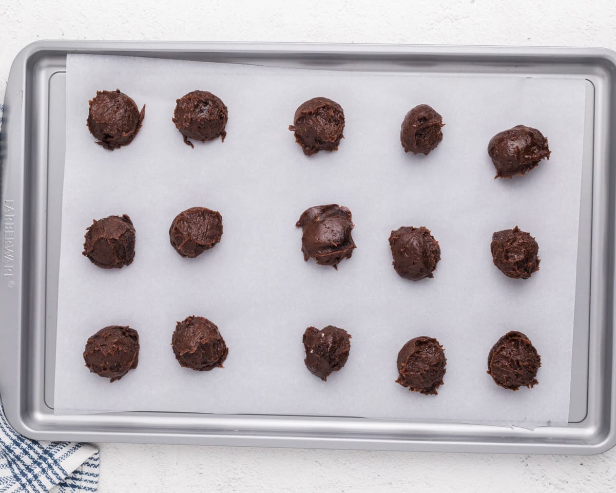 dollops of brownie batter on a baking sheet