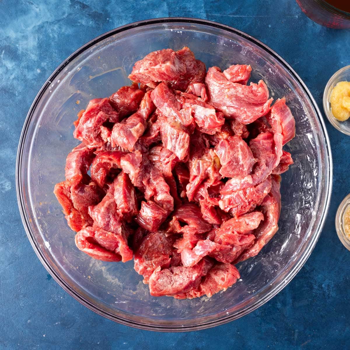 seasoned steak strips in a bowl