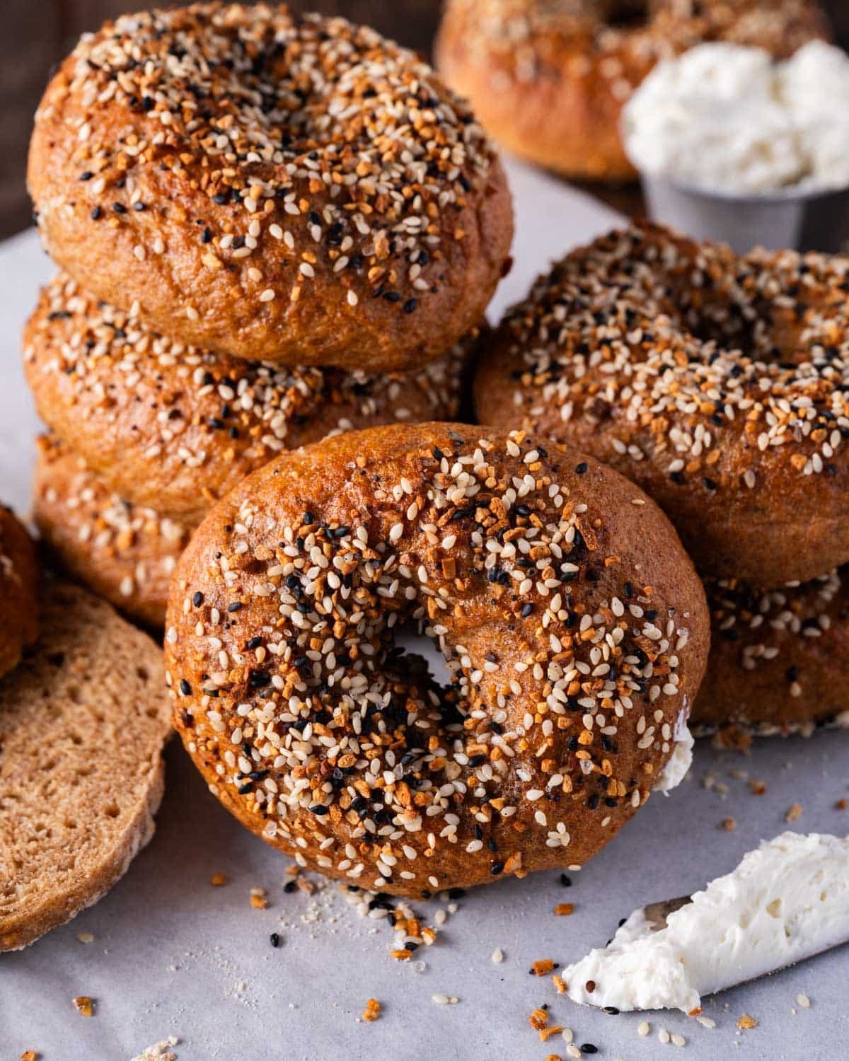 a stack of whole wheat bagels on a table