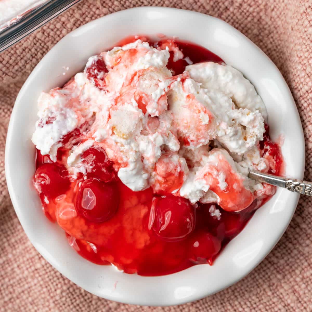 a bowl of angel food cake dessert with cherry pie filling