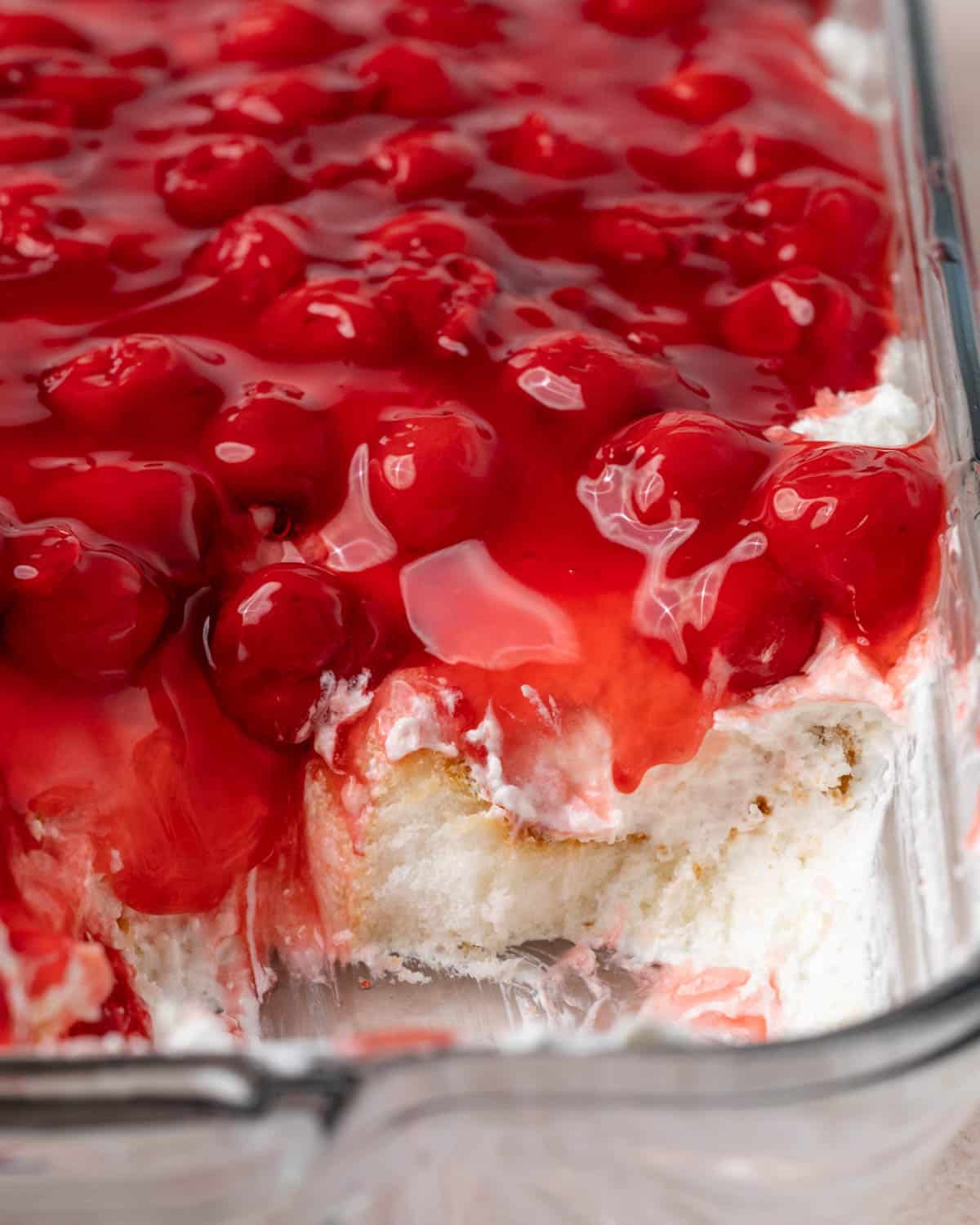 closeup of angel food cake, whipped cream and cherry pie filling dessert