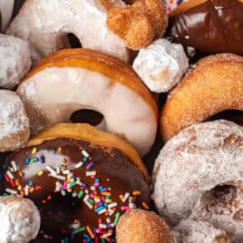 box of homemade donuts with donut holes on top