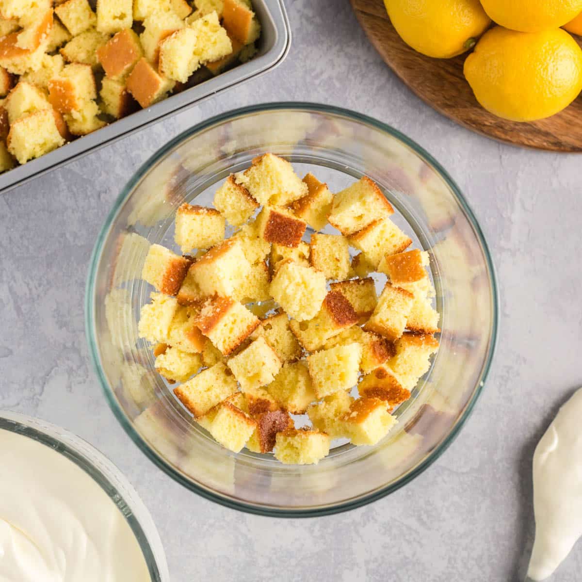 cubes of lemon cake in a glass trifle dish