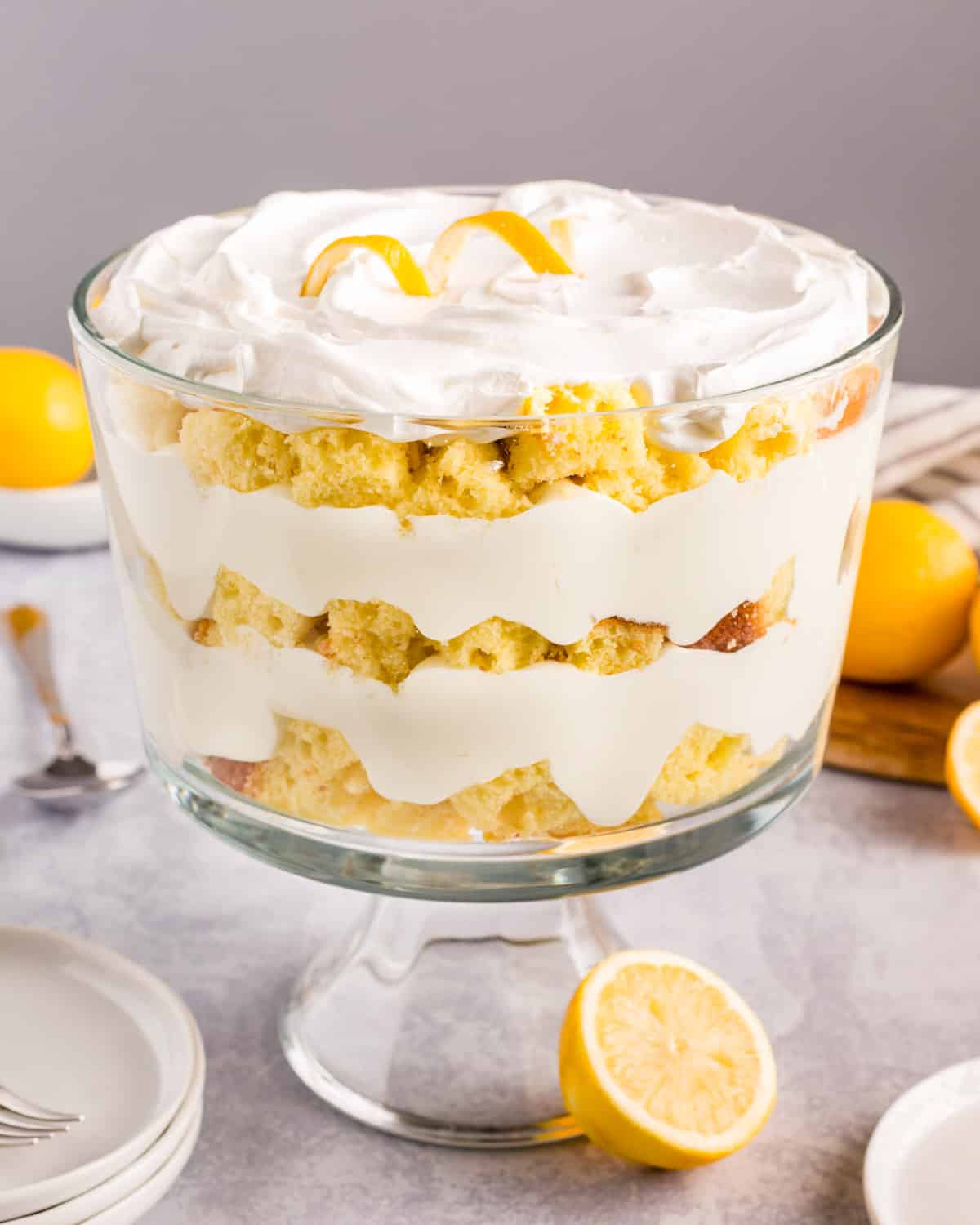 lemon trifle on a table with whipped cream and cake layers