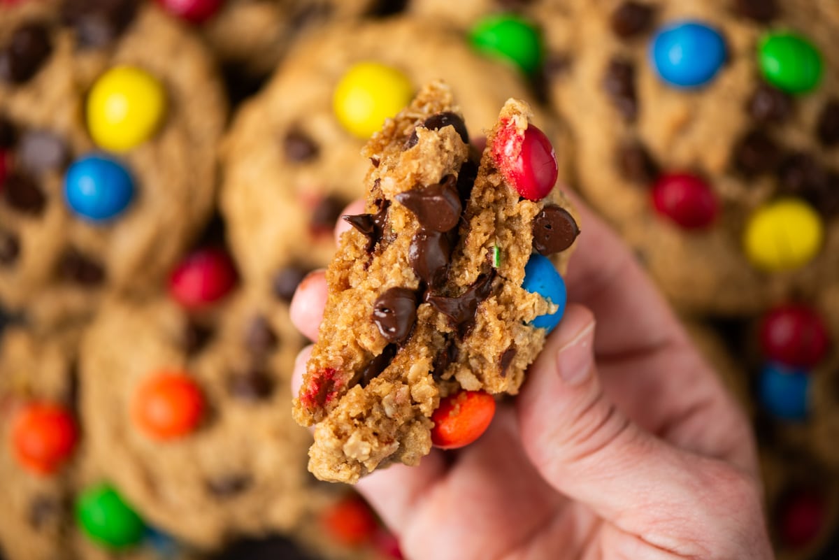 a hand holding a cookie broken in half