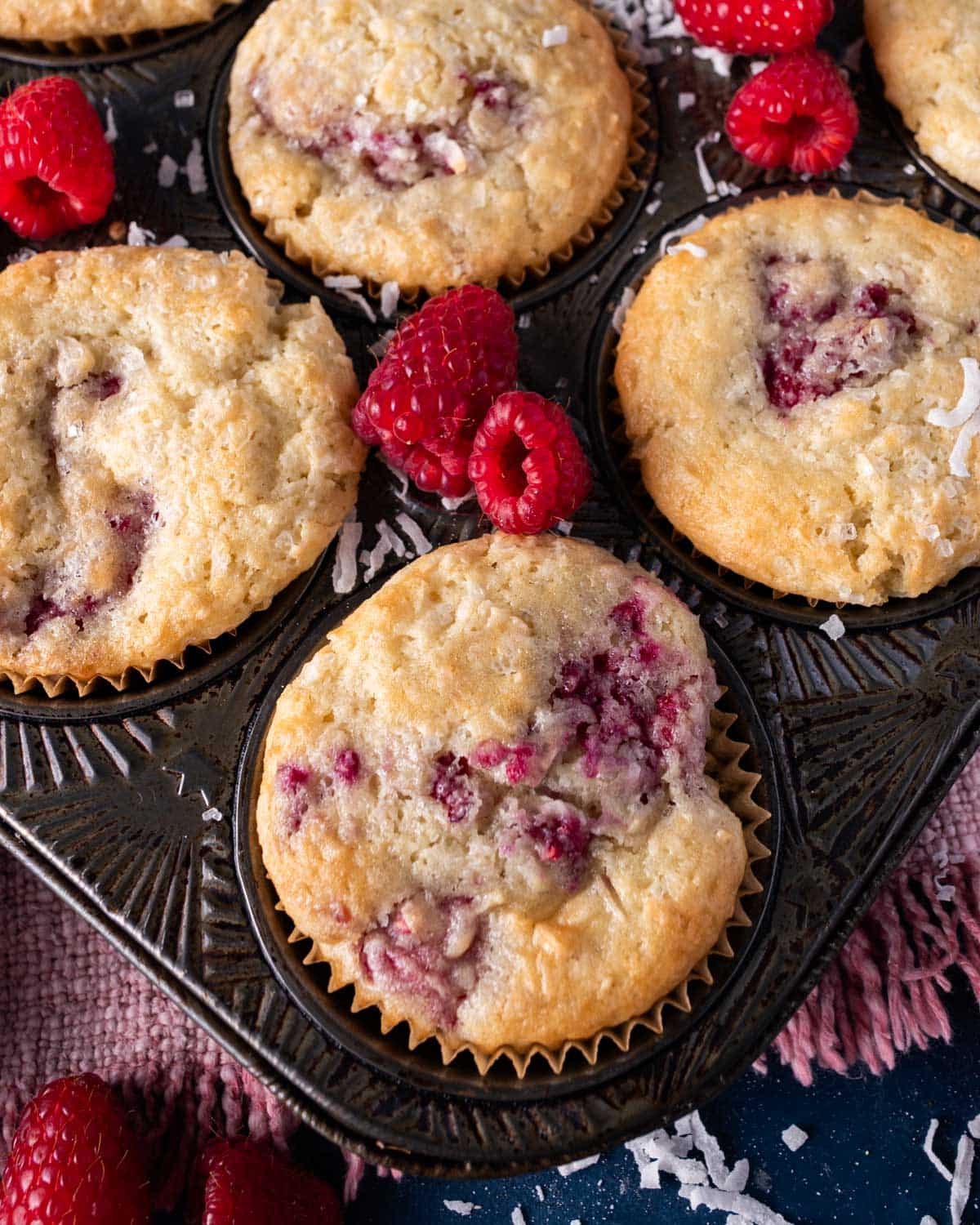 baked raspberry coconut muffins in a pan