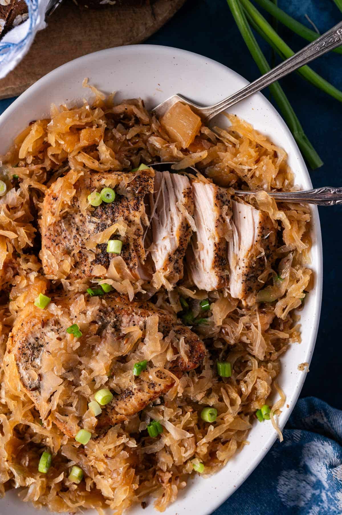 fork tender pork chops and sauerkraut on a plate