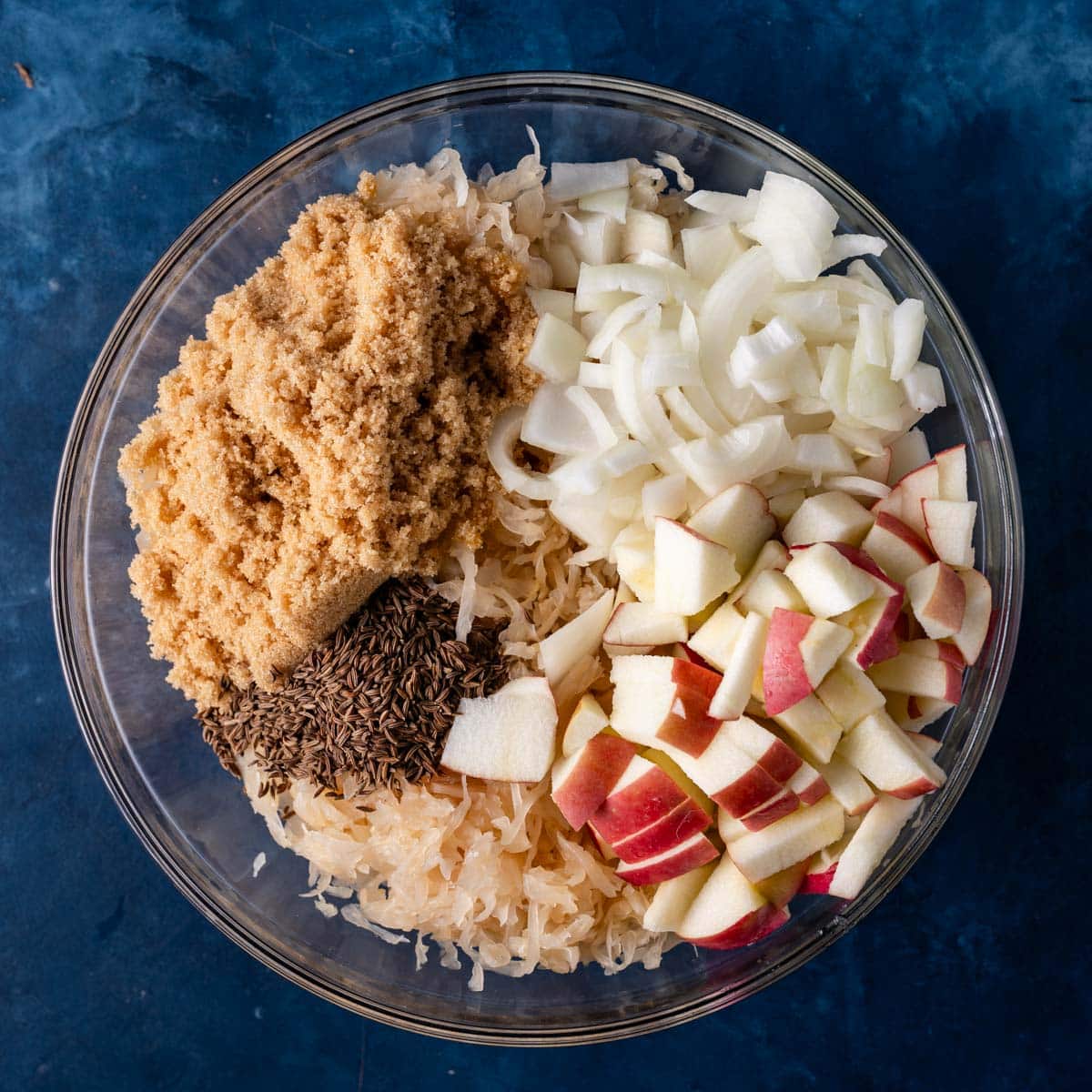 apple sweetened sauerkraut ingredients in a bowl, unmixed