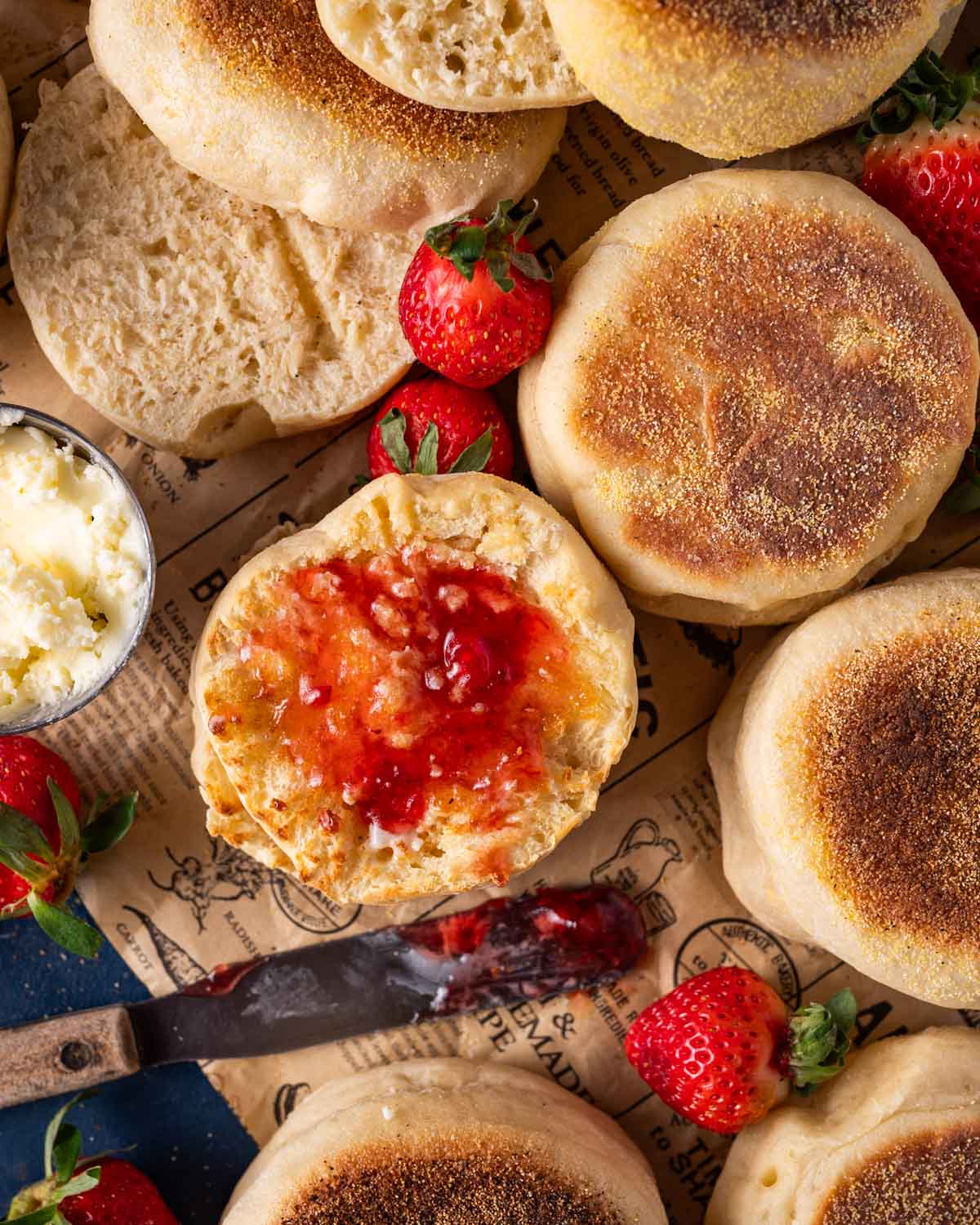 sourdough english muffins on a table with butter and jam