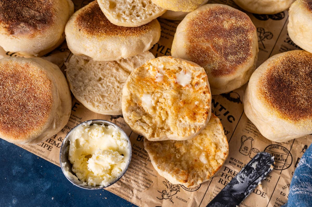 sourdough discard english muffins on a table with butter