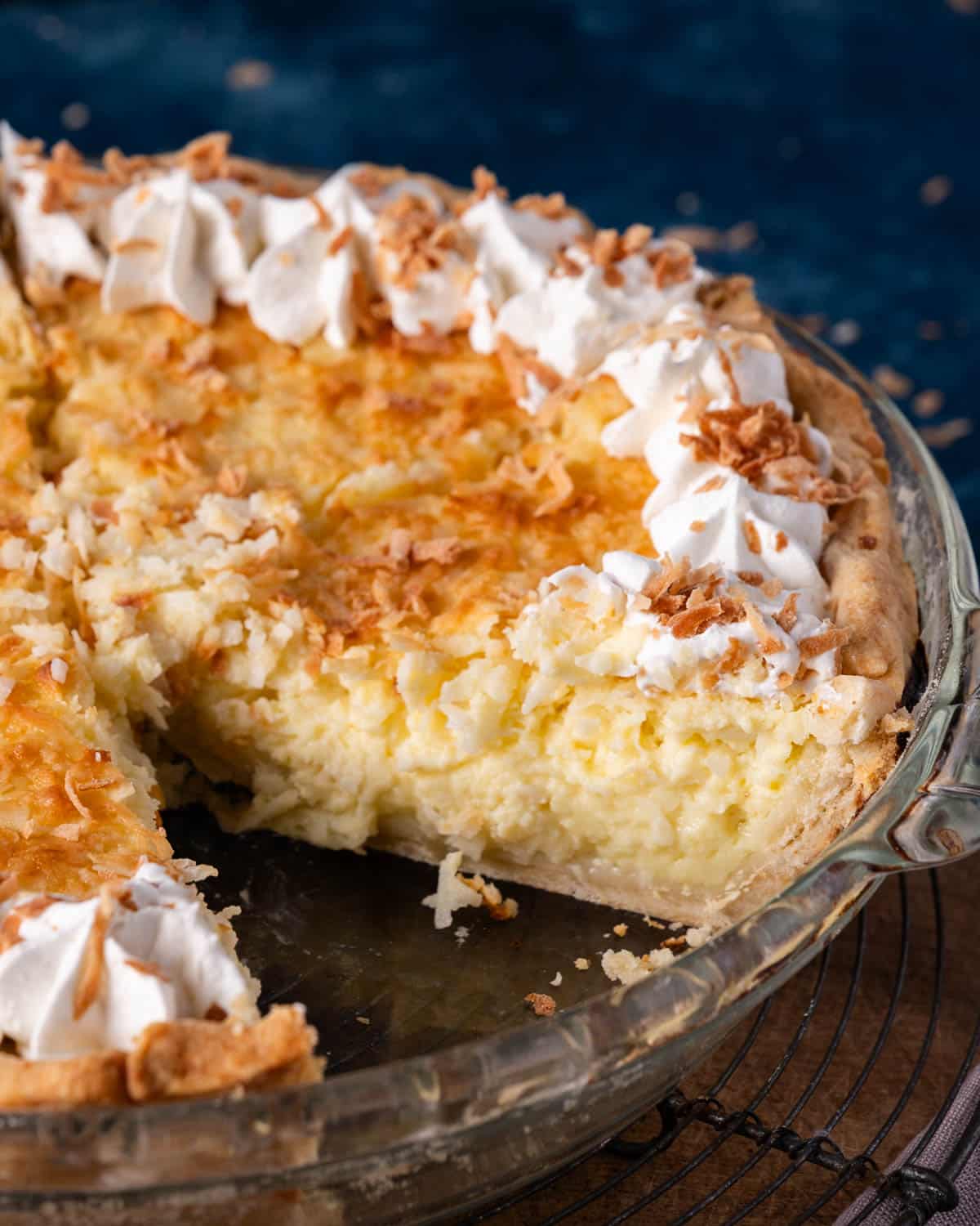 a coconut custard pie with one slice out