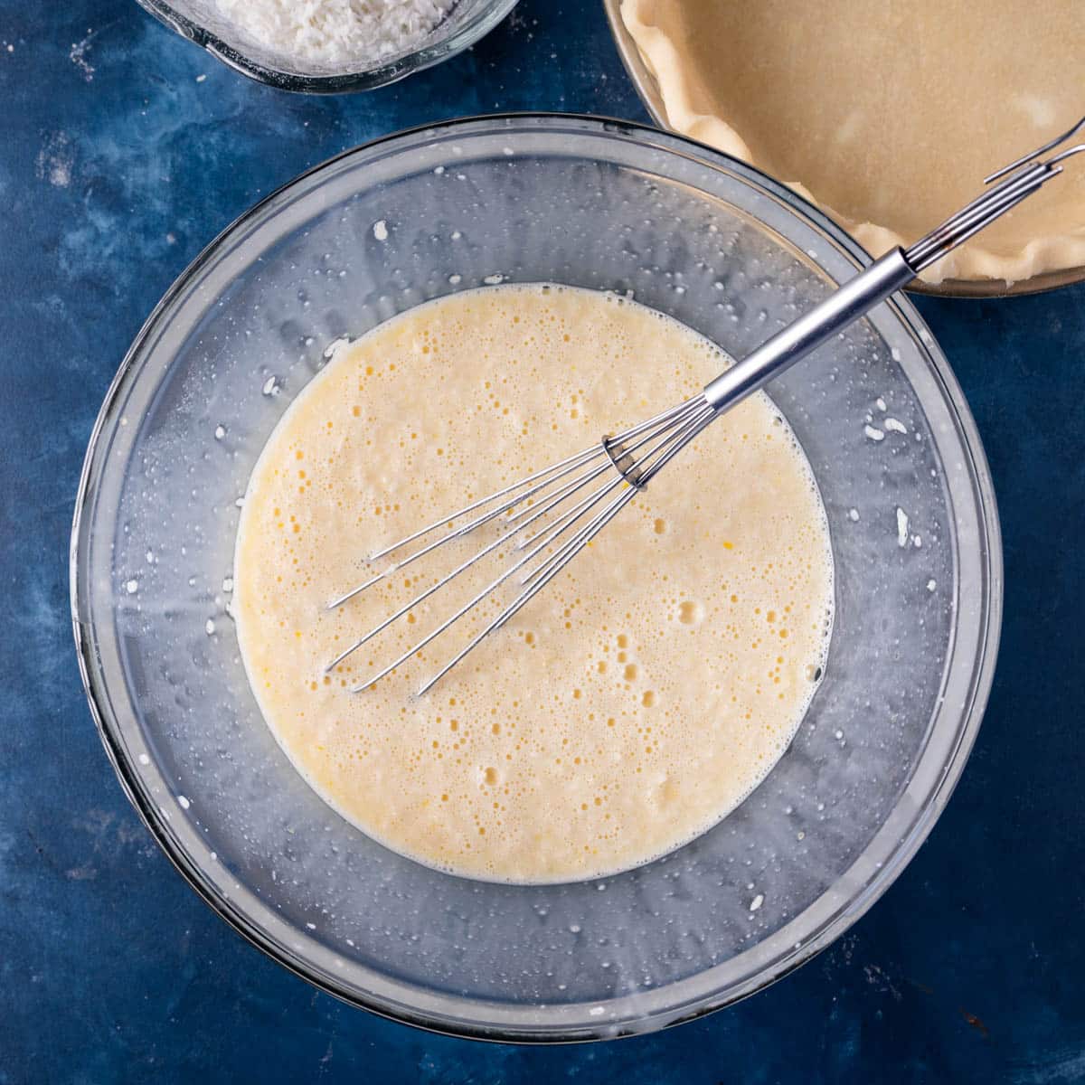 eggs, milk and coconut mixed in a bowl