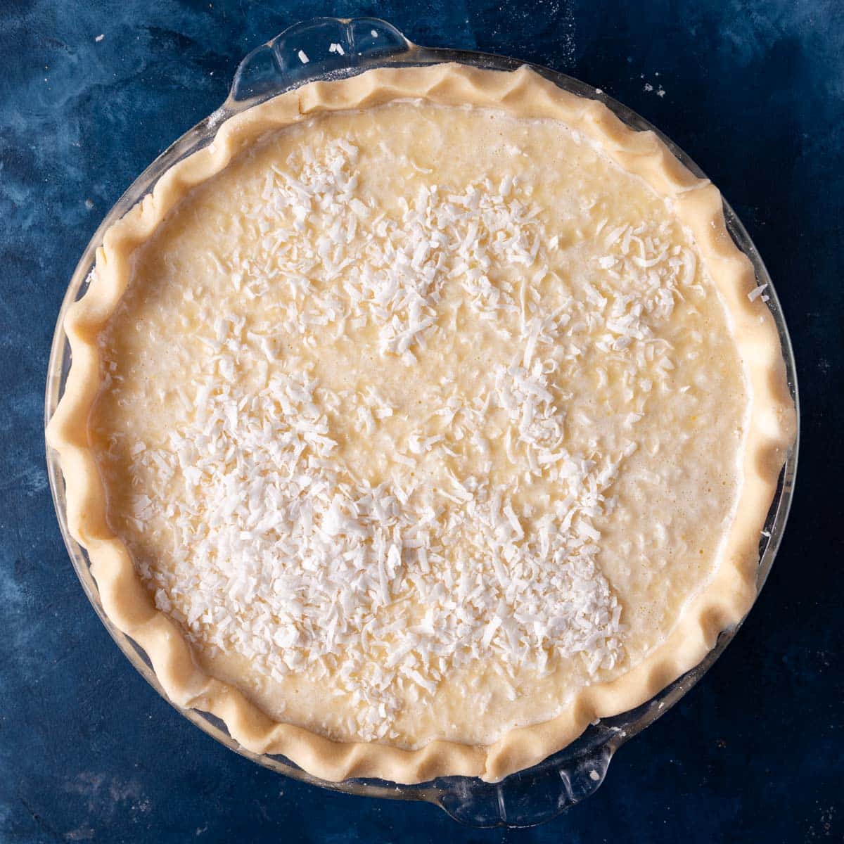 unbaked coconut custard pie on a table