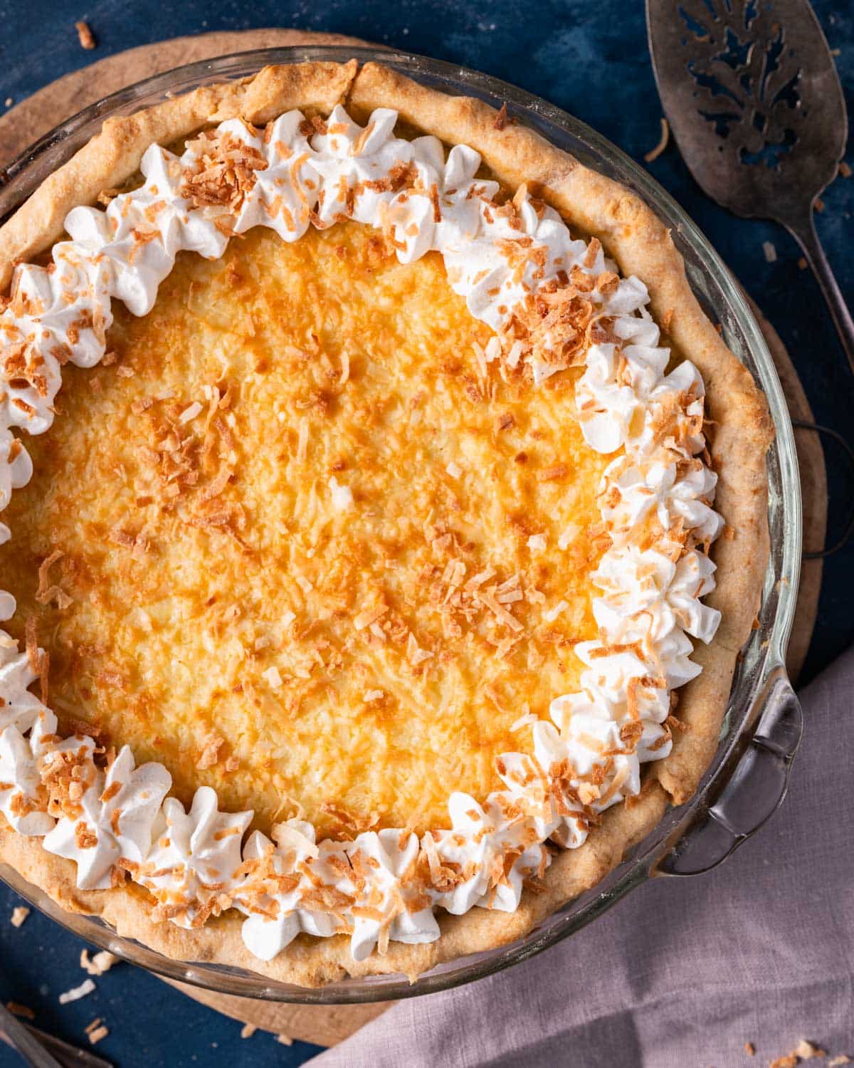 coconut custard pie with shredded coconut and whipped cream