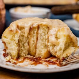 half of a cinnamon roll on a plate