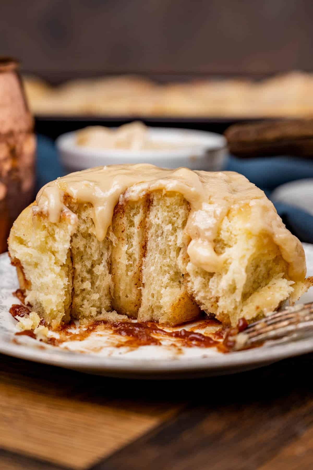 half of a cinnamon roll on a plate